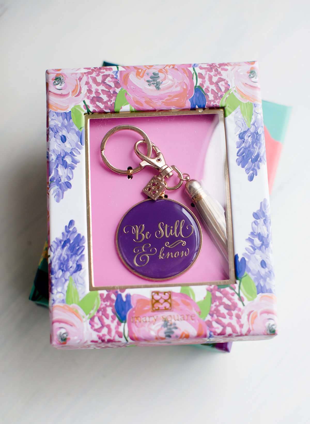 Be still and know purple keychain with gold tassel.