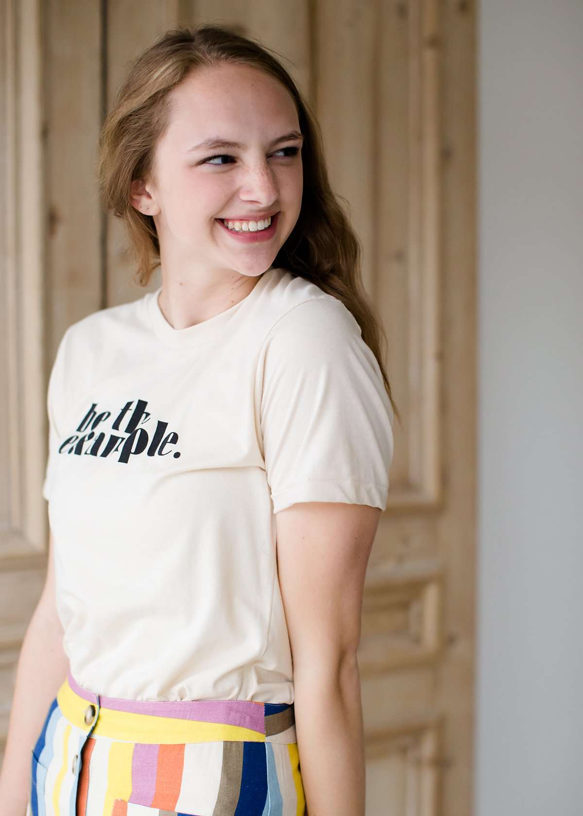 be the example cream colored graphic tee