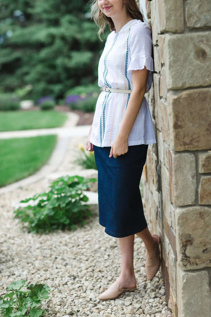 Modest white belle-sleeve top with Earthy colored embroidery down the front.