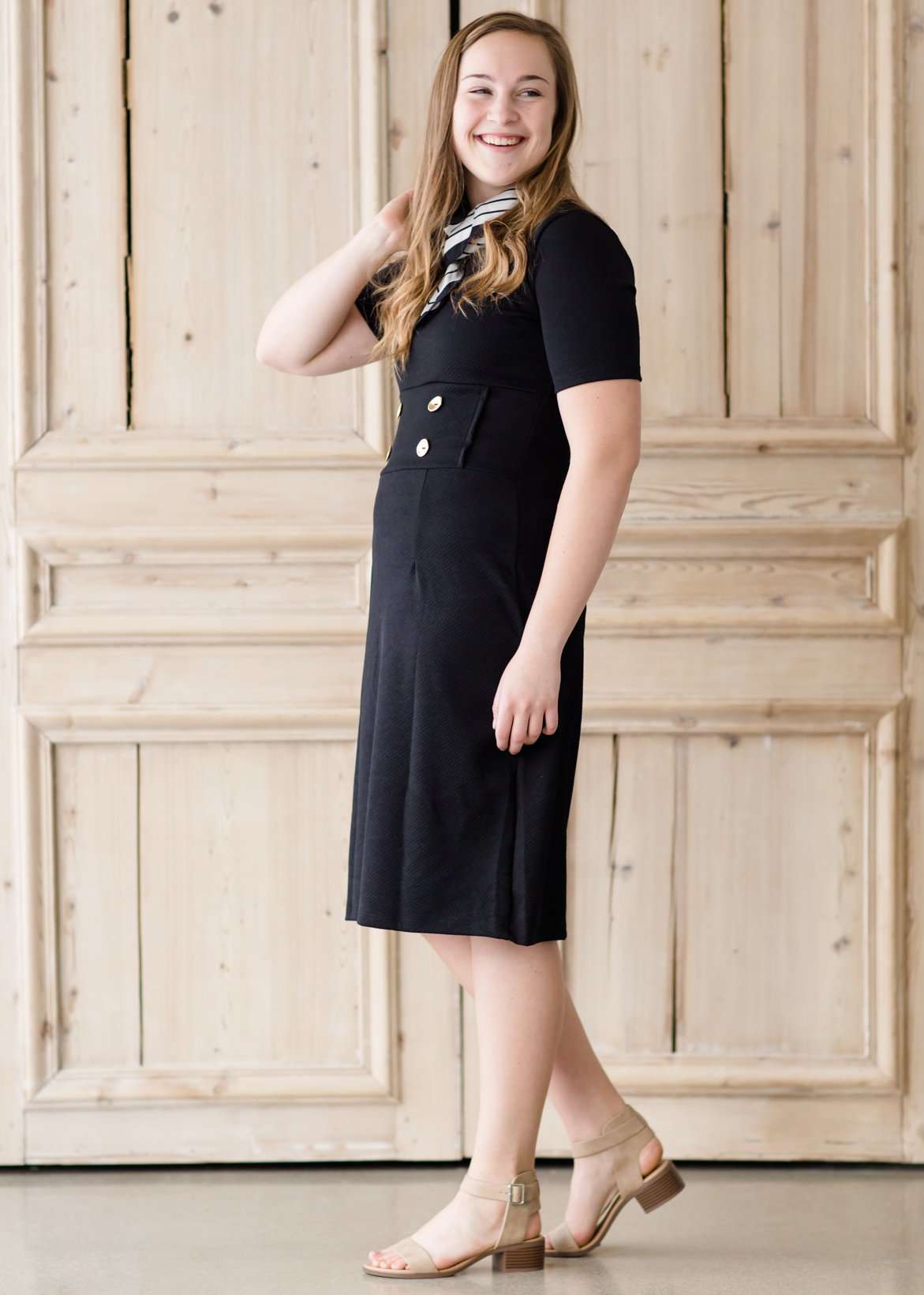 modest black midi dress with gold button accent