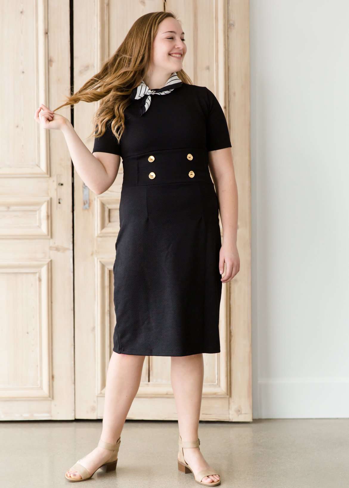 modest black midi dress with gold button accent