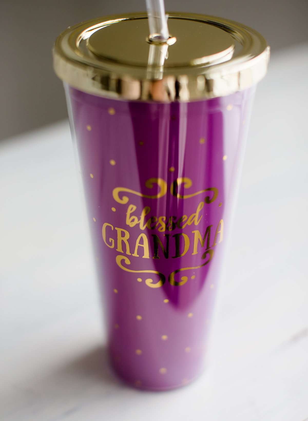 Purple and gold double wall tumbler that says blessed grandma on it.