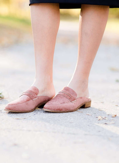 Woman wearing a classic copper colored backless genuine leather loafer