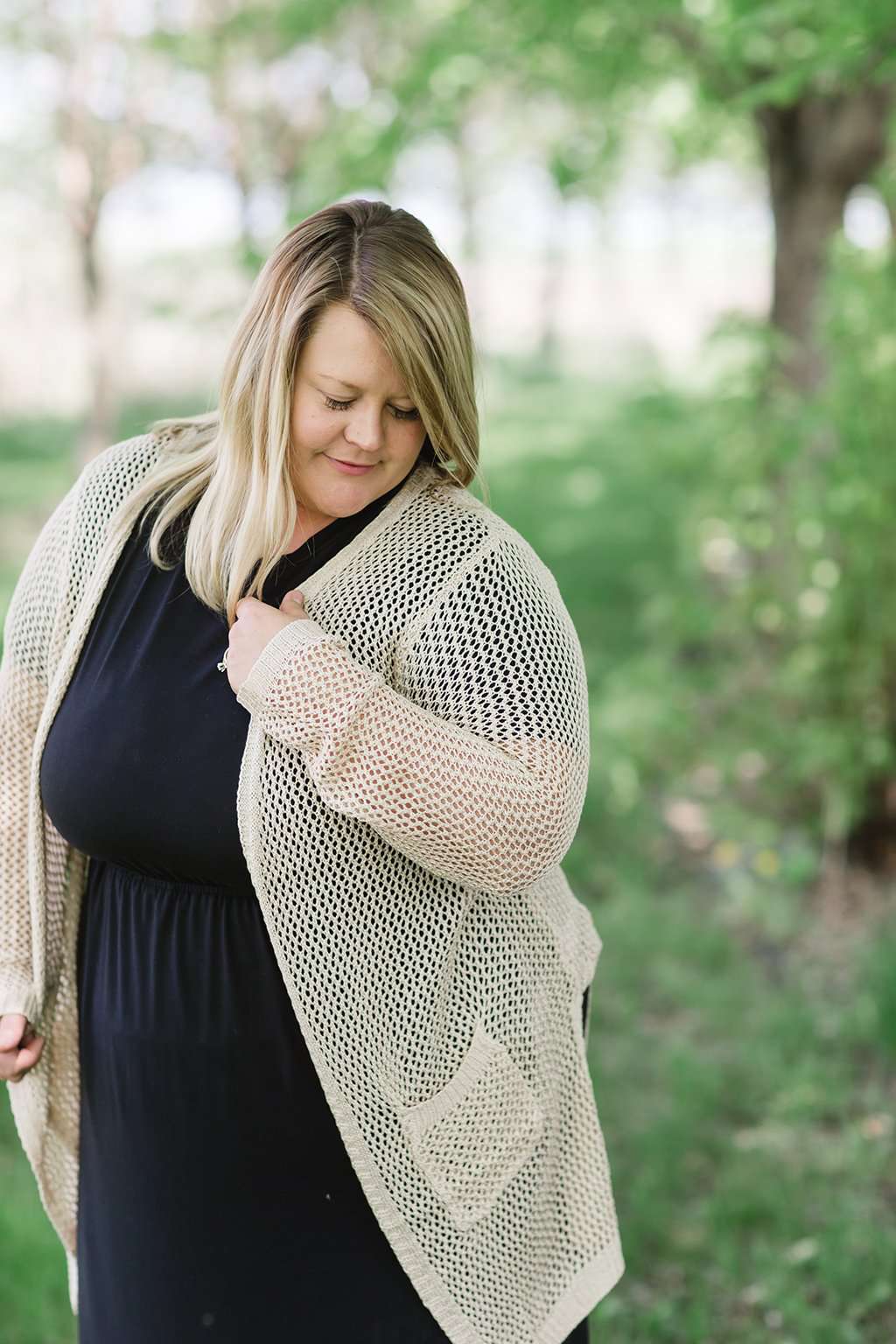 blush or taupe crochet knit cardigan with open front and two side pockets.