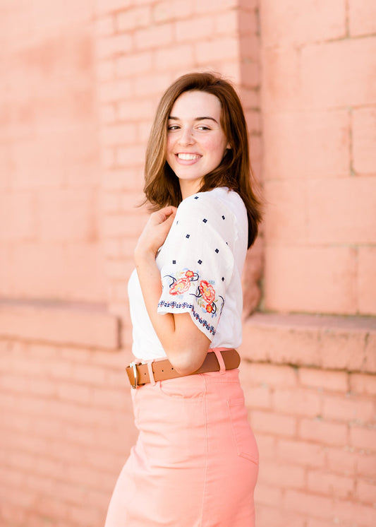 White top with multi color floral embroidered knit sleeves