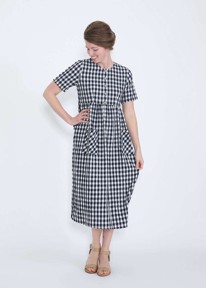 woman wearing a navy and white gingham print midi dress