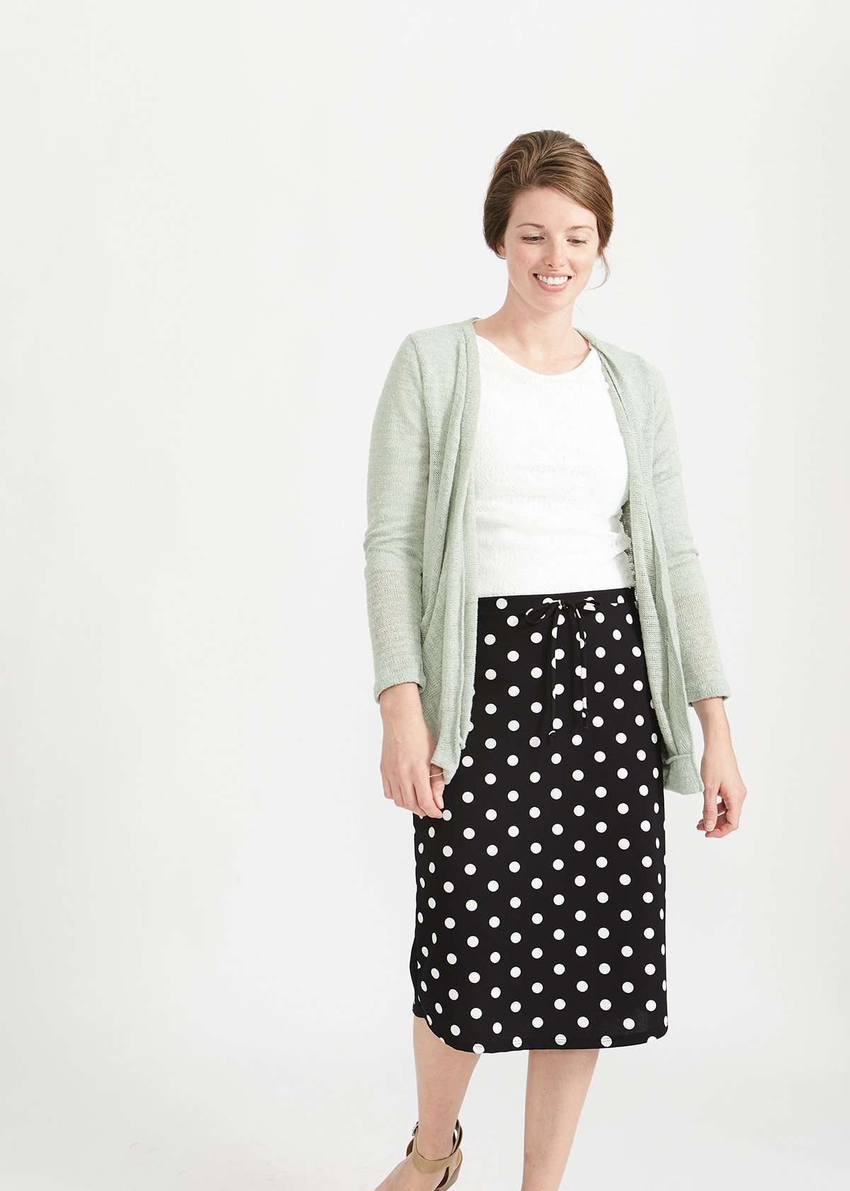 Woman wearing black and white stretch polka dot dress skirt