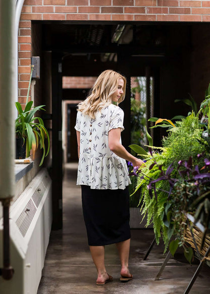 greenery patterned peplum white top with faux buttons on back