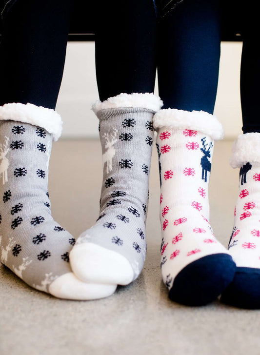 Reindeer Christmas scene slipper socks in gray, cream and black.